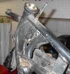 This one came equipped with an RD400 swing-arm and rear caliper. I've pulled the caliper off as I don't intend to use an RD400 aluminum wheel. It also had this spike shaped deal welded on at the head stock. I guess it's for a fairing brace but the damned thing looks dangerous to me...